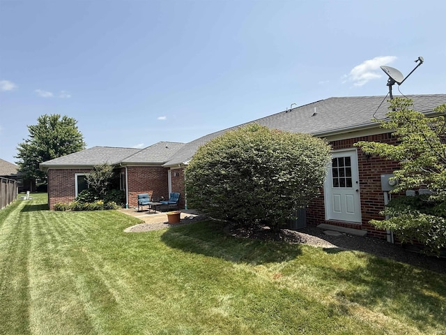 5844 Flagstone Dr, Evansville, IN 47711 - back of property with brick siding, a yard, a patio, and a shingled roof