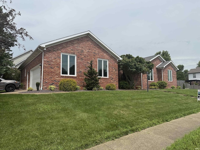 5844 Flagstone Dr, Evansville, IN 47711 - view of front facade with brick siding, an attached garage, and a front yard
