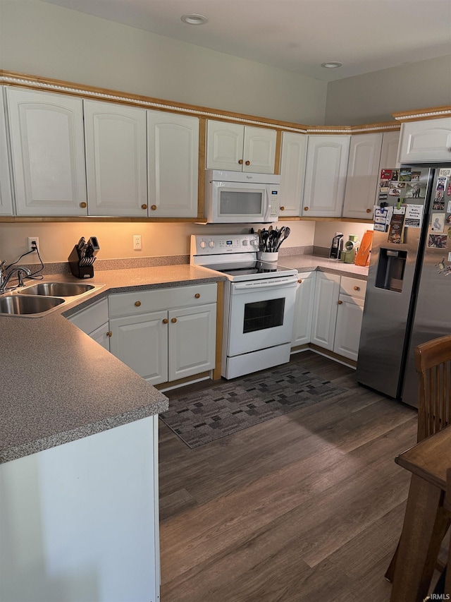 5844 Flagstone Dr, Evansville, IN 47711 - kitchen with white appliances, dark wood-style flooring, white cabinets, and recessed lighting