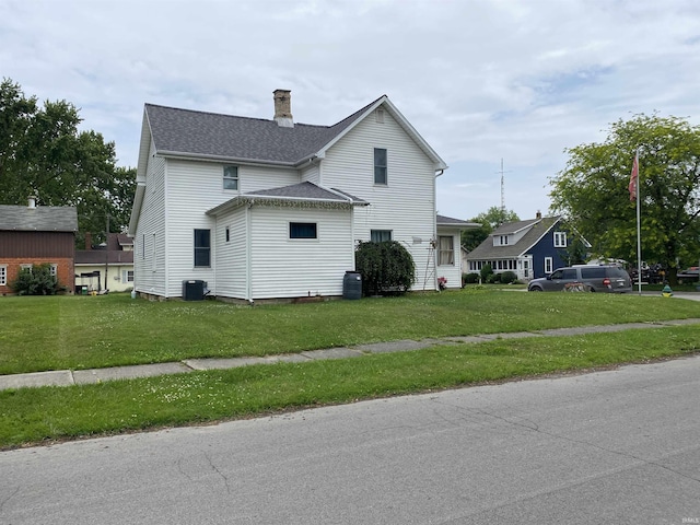 506 N Sprunger St, Berne, IN 46711 - view of home's exterior with a chimney, a lawn, and a shingled roof