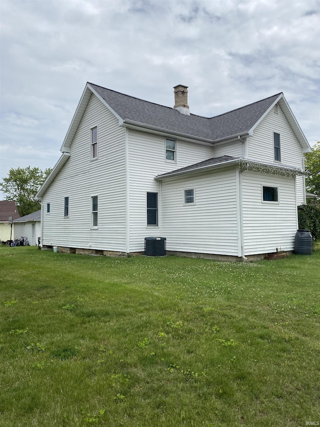 506 N Sprunger St, Berne, IN 46711 - view of home's exterior with a chimney, a yard, and a shingled roof
