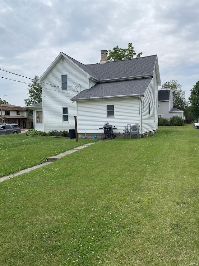 506 N Sprunger St, Berne, IN 46711 - view of property exterior featuring a chimney, a yard, and roof with shingles