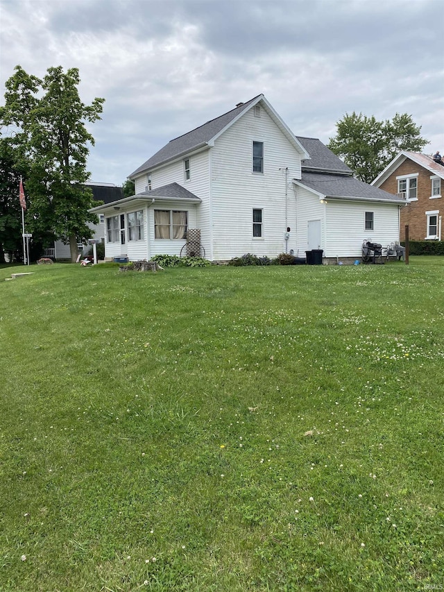 506 N Sprunger St, Berne, IN 46711 - rear view of property featuring a yard and a shingled roof