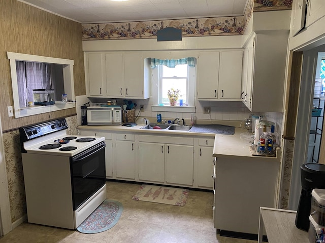 506 N Sprunger St, Berne, IN 46711 - kitchen with white appliances, light countertops, white cabinetry, and wallpapered walls