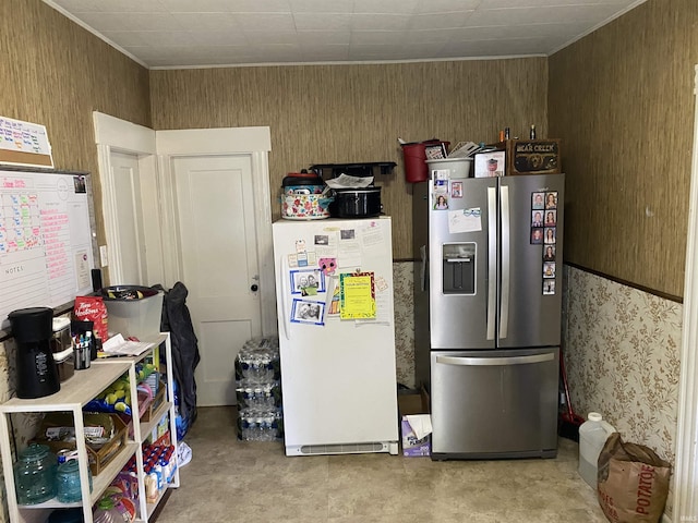 506 N Sprunger St, Berne, IN 46711 - kitchen with stainless steel fridge, freestanding refrigerator, ornamental molding, and wooden walls