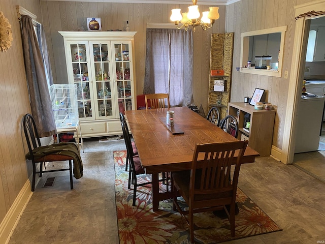 506 N Sprunger St, Berne, IN 46711 - dining room with a chandelier, wood walls, and ornamental molding