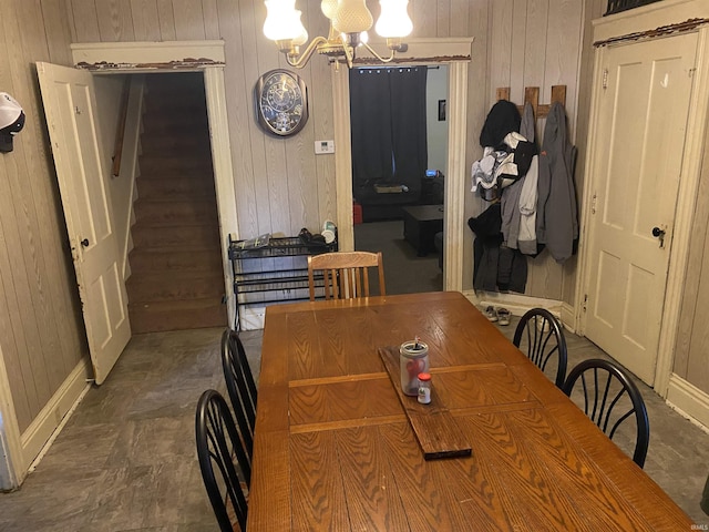 506 N Sprunger St, Berne, IN 46711 - dining space featuring wooden walls, a chandelier, and stairs