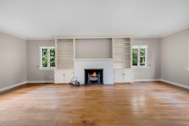 1402 Jackson Rd, South Bend, IN 46614 - unfurnished living room featuring ornamental molding, a fireplace, and light wood-type flooring