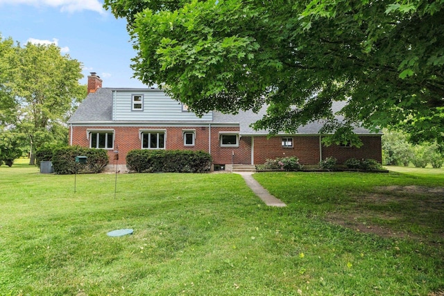 1402 Jackson Rd, South Bend, IN 46614 - rear view of property with brick siding, a lawn, and a chimney