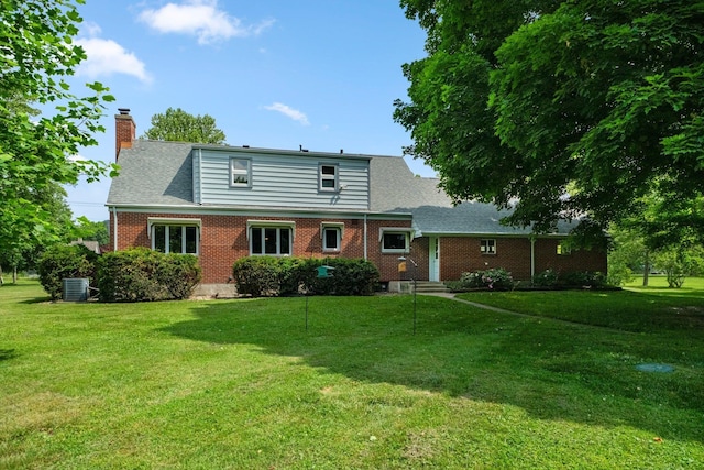 1402 Jackson Rd, South Bend, IN 46614 - rear view of property with a chimney, a lawn, brick siding, and roof with shingles