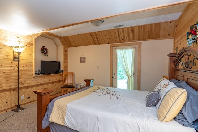 1275 N Sewell Rd, Bloomington, IN 47408 - bedroom featuring wooden walls, vaulted ceiling, and carpet flooring