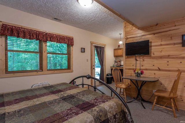 1275 N Sewell Rd, Bloomington, IN 47408 - bedroom with carpet, wood walls, and a textured ceiling