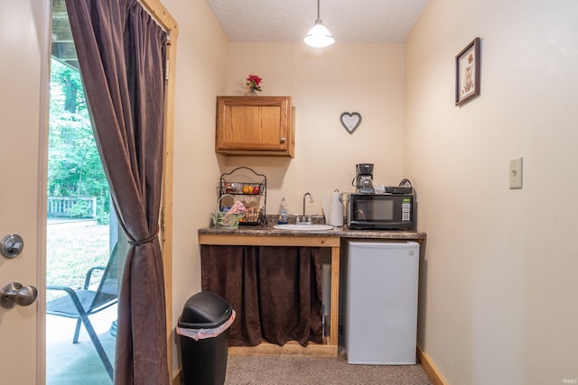 1275 N Sewell Rd, Bloomington, IN 47408 - bar with black microwave, light colored carpet, fridge, and decorative light fixtures