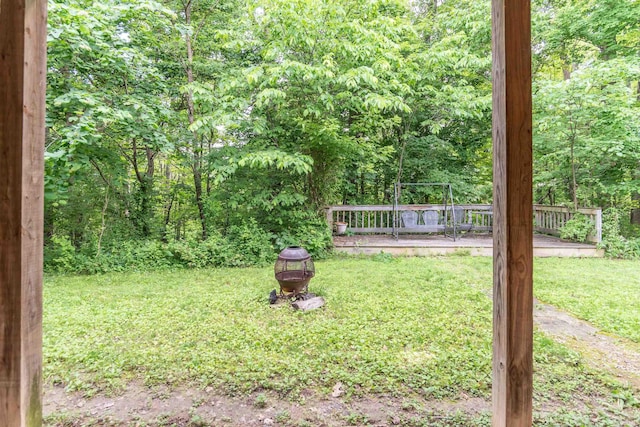 1275 N Sewell Rd, Bloomington, IN 47408 - view of grassy yard featuring a deck and a wooded view