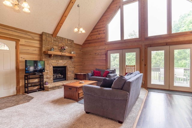 1275 N Sewell Rd, Bloomington, IN 47408 - living area with a chandelier, high vaulted ceiling, a stone fireplace, wood walls, and beam ceiling