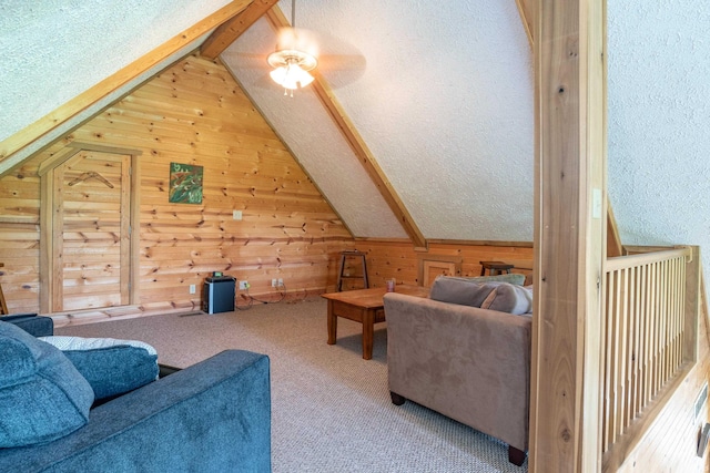 1275 N Sewell Rd, Bloomington, IN 47408 - carpeted living area featuring wooden walls, lofted ceiling, ceiling fan, and a textured ceiling