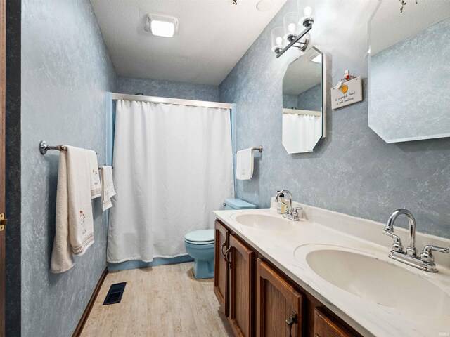 3723 Pebblewood Pl, Fort Wayne, IN 46804 - bathroom featuring wood finished floors, double vanity, and a textured wall