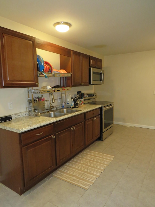 219 Fulton Ave, Rochester, IN 46975 - kitchen featuring stainless steel appliances, light countertops, light tile patterned floors, and open shelves