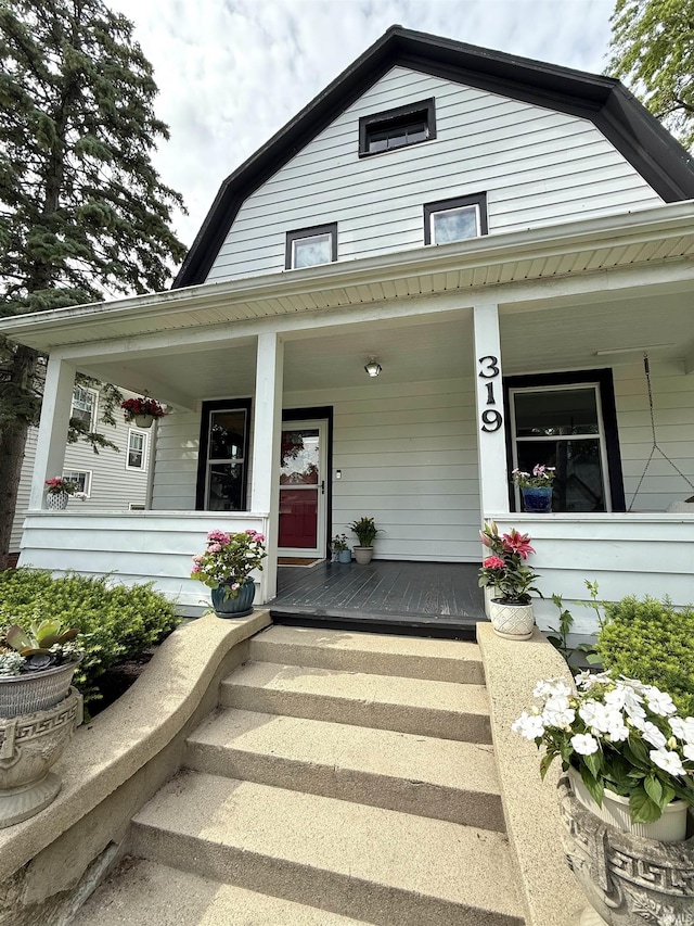319 W Wiley Ave, Bluffton, IN 46714 - property entrance featuring a porch and a gambrel roof