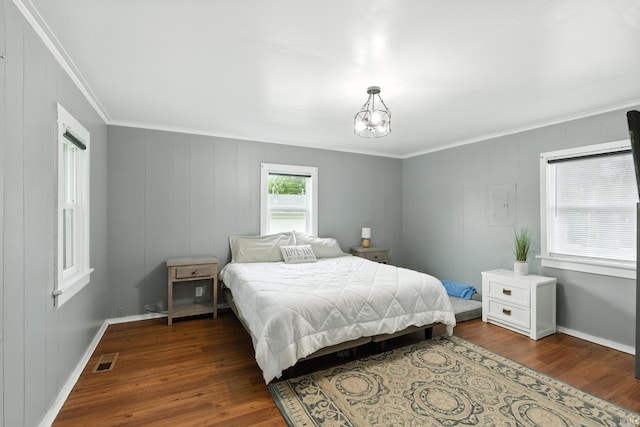 319 W Wiley Ave, Bluffton, IN 46714 - bedroom with ornamental molding, dark wood-type flooring, a chandelier, and a decorative wall