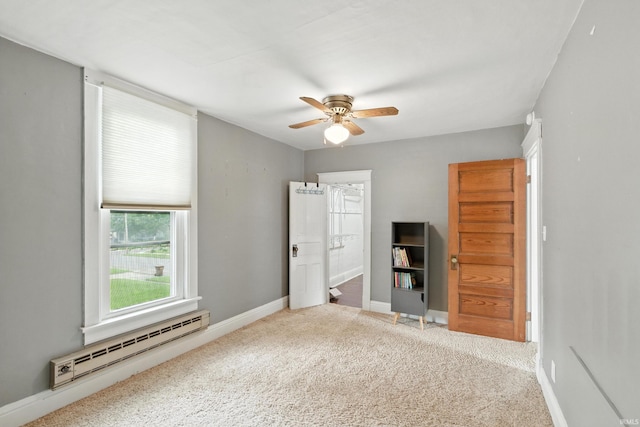 319 W Wiley Ave, Bluffton, IN 46714 - unfurnished bedroom with a baseboard radiator, carpet flooring, a ceiling fan, and connected bathroom
