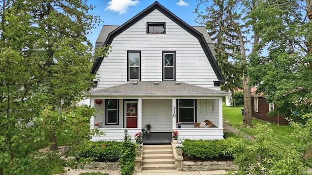 319 W Wiley Ave, Bluffton, IN 46714 - view of front of home with a gambrel roof, covered porch, and a shingled roof