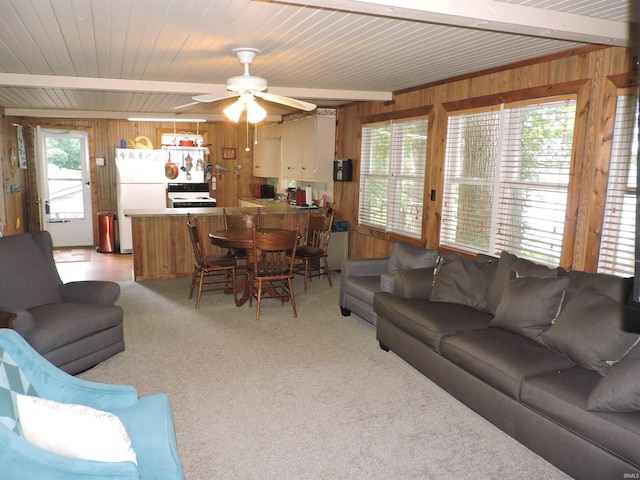 3643 S Bruner Rd, Warsaw, IN 46580 - living area featuring wood walls, light colored carpet, ceiling fan, and a wooden ceiling with exposed beams
