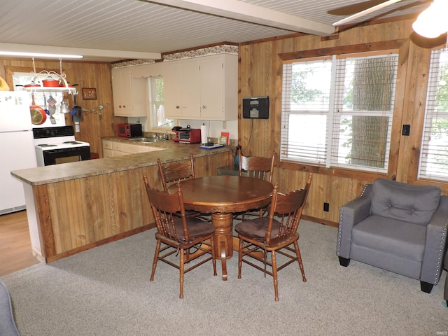 3643 S Bruner Rd, Warsaw, IN 46580 - dining area with wooden walls, beam ceiling, and a ceiling fan