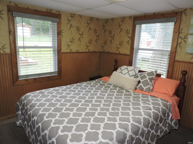 3643 S Bruner Rd, Warsaw, IN 46580 - bedroom featuring wallpapered walls, a wainscoted wall, and a paneled ceiling