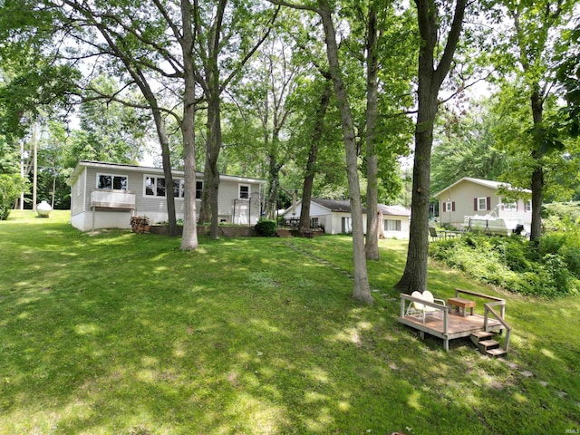 3643 S Bruner Rd, Warsaw, IN 46580 - view of green lawn with a deck and view of scattered trees