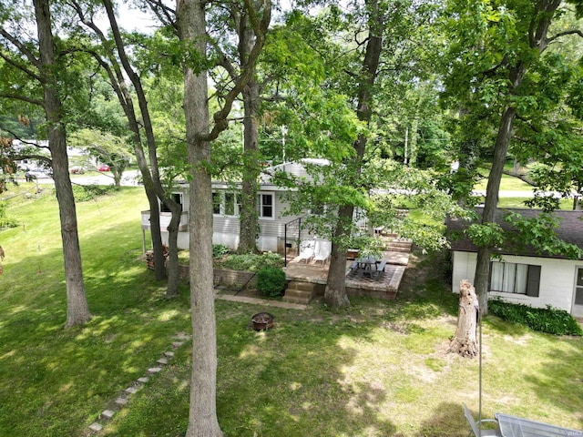 3643 S Bruner Rd, Warsaw, IN 46580 - view of green lawn with an outdoor fire pit and a wooden deck