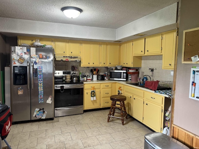 2286 N County Road 200 W, New Castle, IN 47362 - kitchen with stainless steel appliances, backsplash, light countertops, a textured ceiling, and under cabinet range hood