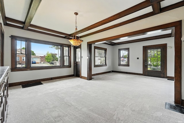 501 E Center St, Warsaw, IN 46580 - empty room featuring light colored carpet and beam ceiling