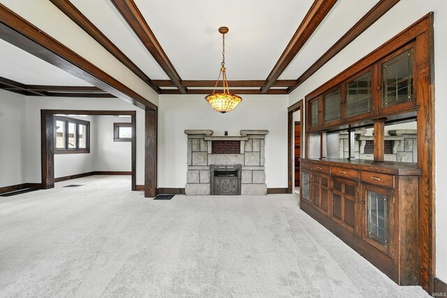 501 E Center St, Warsaw, IN 46580 - unfurnished living room with carpet floors, beam ceiling, and a fireplace