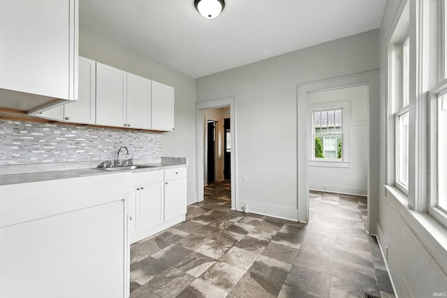 501 E Center St, Warsaw, IN 46580 - kitchen with light countertops, white cabinetry, and tasteful backsplash