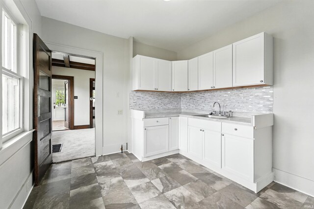501 E Center St, Warsaw, IN 46580 - kitchen featuring light countertops, decorative backsplash, and white cabinets