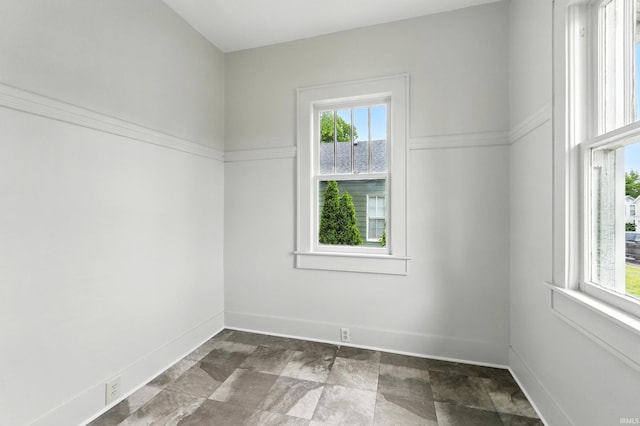 501 E Center St, Warsaw, IN 46580 - unfurnished room with baseboards and dark stone finish floors