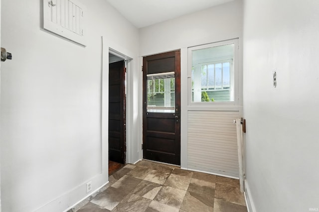 501 E Center St, Warsaw, IN 46580 - doorway to outside with baseboards and stone finish floors