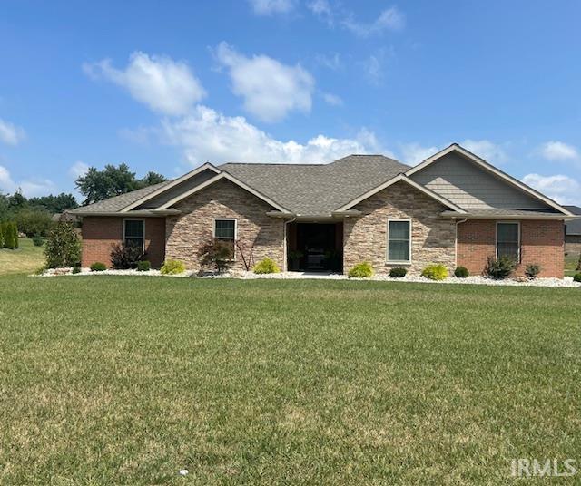 855 Reyling Dr, Jasper, IN 47546 - craftsman-style house featuring a front yard and stone siding