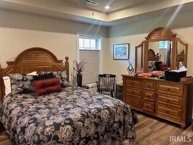 855 Reyling Dr, Jasper, IN 47546 - bedroom with wood finished floors and a tray ceiling