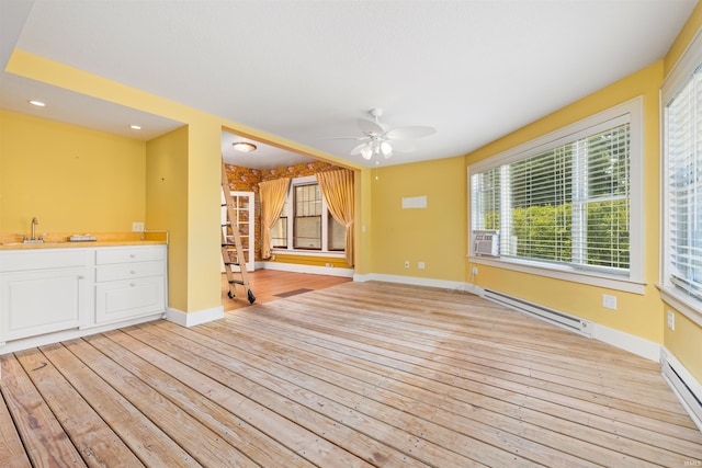2131 Kensington Blvd, Fort Wayne, IN 46805 - unfurnished living room featuring a baseboard heating unit, light wood-style flooring, a ceiling fan, and recessed lighting