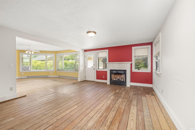 2131 Kensington Blvd, Fort Wayne, IN 46805 - unfurnished living room featuring a baseboard heating unit, light wood finished floors, a fireplace, and cooling unit