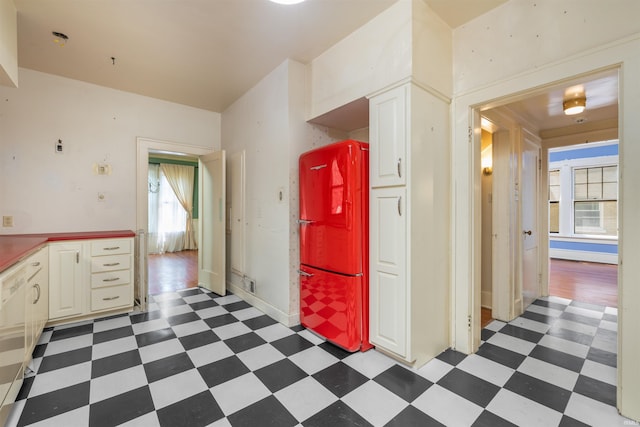 2131 Kensington Blvd, Fort Wayne, IN 46805 - kitchen with light floors, freestanding refrigerator, and white cabinets