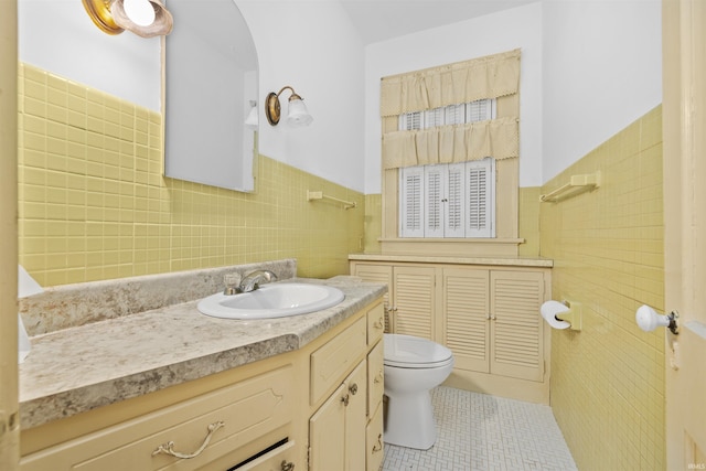 2131 Kensington Blvd, Fort Wayne, IN 46805 - bathroom featuring tile walls, vanity, tile patterned flooring, and a wainscoted wall