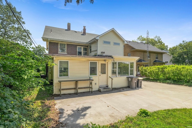 2131 Kensington Blvd, Fort Wayne, IN 46805 - back of house with a patio, a chimney, and roof with shingles