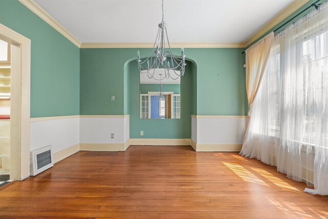 2131 Kensington Blvd, Fort Wayne, IN 46805 - unfurnished room with a chandelier, arched walkways, plenty of natural light, wood finished floors, and crown molding