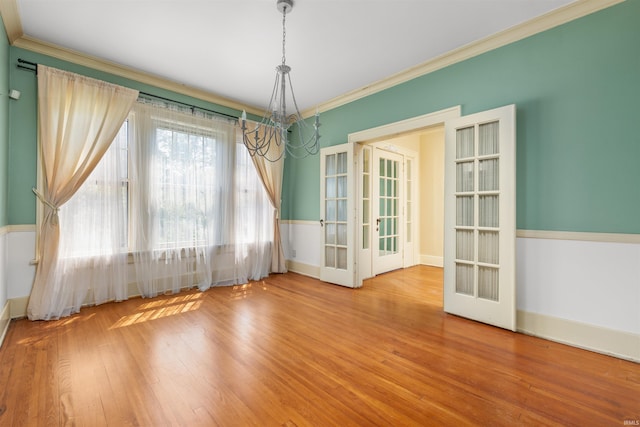 2131 Kensington Blvd, Fort Wayne, IN 46805 - unfurnished dining area featuring french doors, a chandelier, crown molding, and wood finished floors