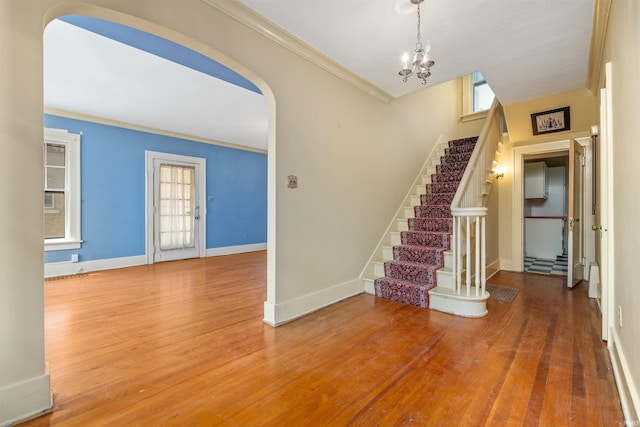 2131 Kensington Blvd, Fort Wayne, IN 46805 - foyer entrance featuring stairway, wood finished floors, arched walkways, crown molding, and a chandelier