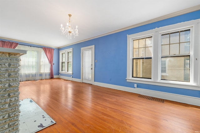2131 Kensington Blvd, Fort Wayne, IN 46805 - unfurnished living room with a chandelier, ornamental molding, and wood finished floors
