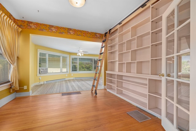 2131 Kensington Blvd, Fort Wayne, IN 46805 - spare room featuring a baseboard radiator, wood finished floors, and cooling unit